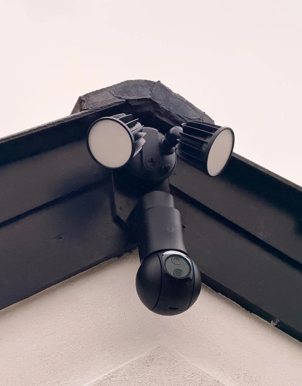 Outdoor PTZ security camera installed beneath the gable at the Waikiki home