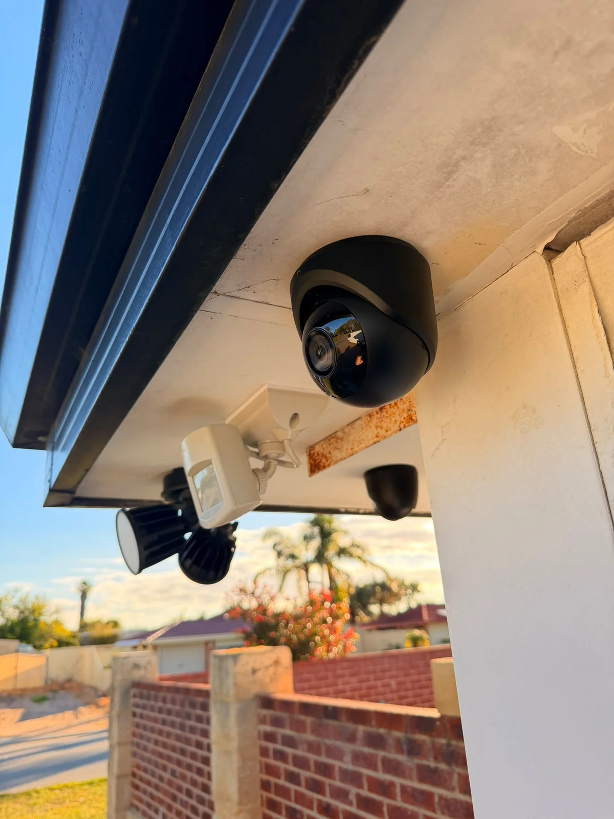 Turret security camera installed beneath the roofline at the Waikiki home