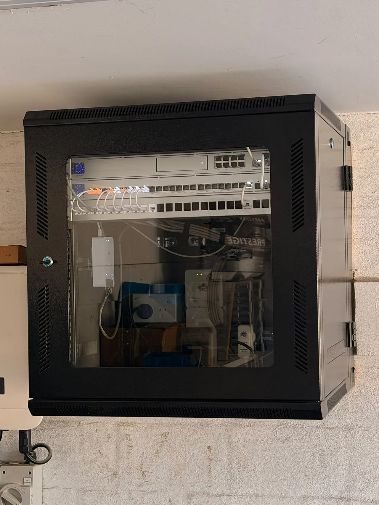 Wall-mounted communications cabinet in an installation